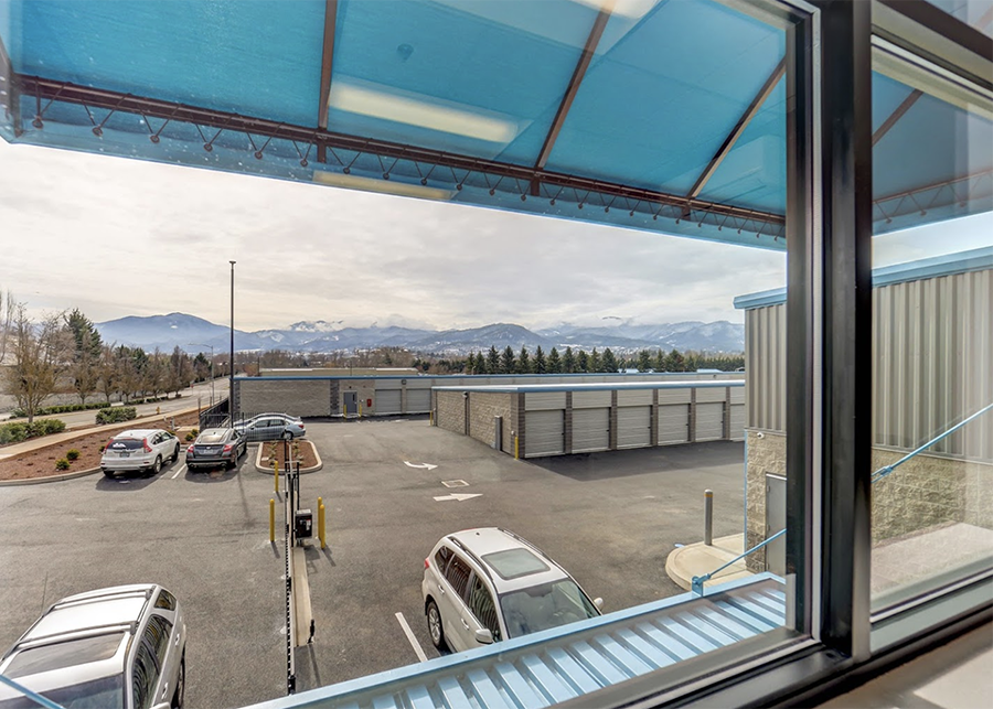 Looking out at the parking lot from the administration building rolling hills and snowcapped mountains in the distance